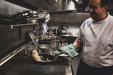 Chef cooking in a pub kitchen